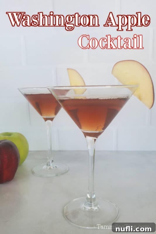 Washington Apple Cocktail over two martini glasses with apple slice garnishes