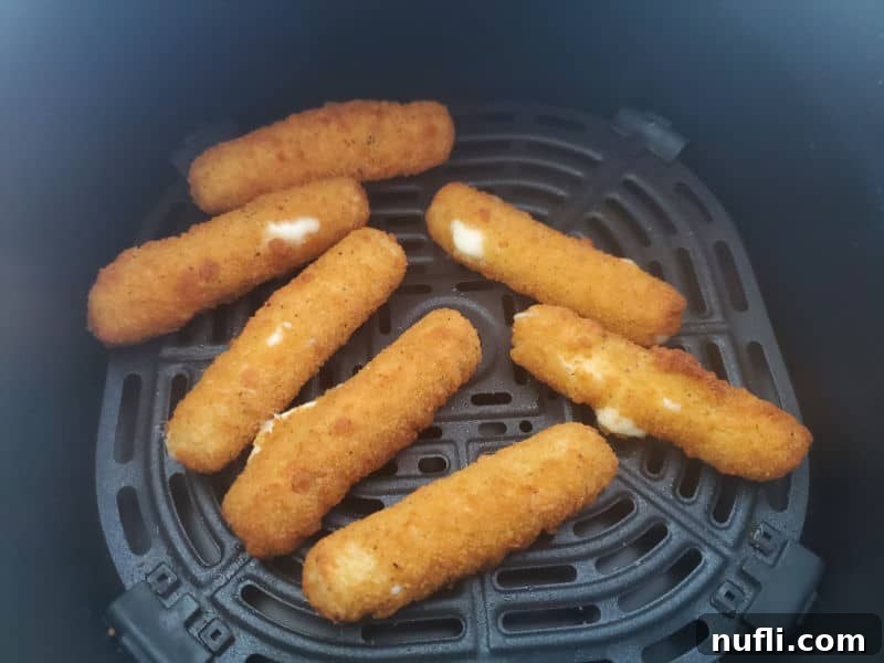 Air fried mozzarella sticks in the air fryer basket