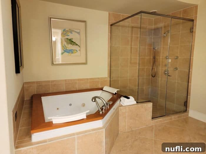 Turquoise Place: Orange Beach Alabama's Luxury Gulf Resort 11 Jacuzzi tub next to a walk in shower with fish art on the wall
