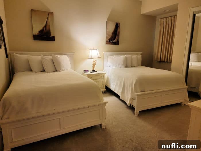 Turquoise Place: Orange Beach Alabama's Luxury Gulf Resort 13 Two beds with a nightstand with a light on