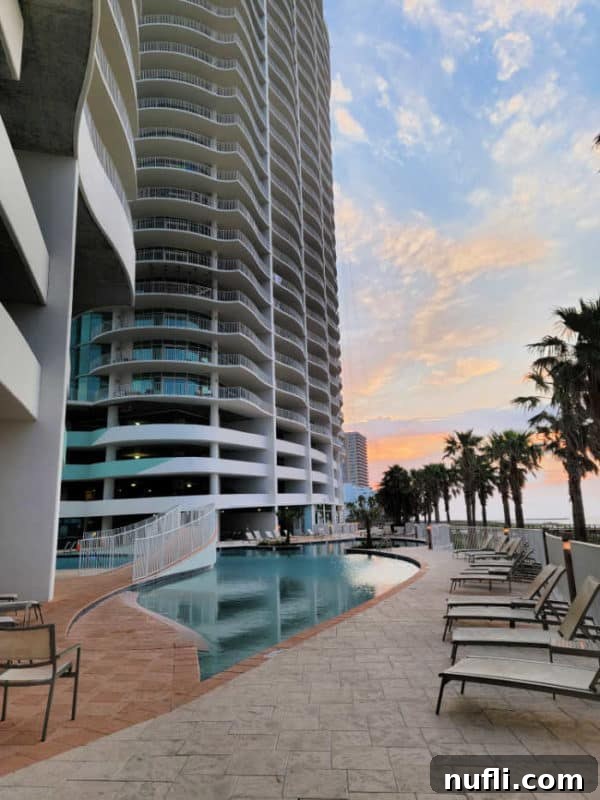 Turquoise Place: Orange Beach Alabama's Luxury Gulf Resort 3 swimming pool with pool chairs below Turquoise Place condo building and palm trees