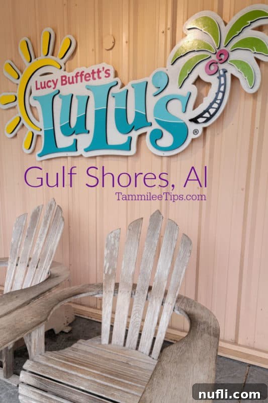 Lucy Buffett's Lulu's Sign with two Adirondack chairs, inviting guests to a fun dining experience in Gulf Shores.