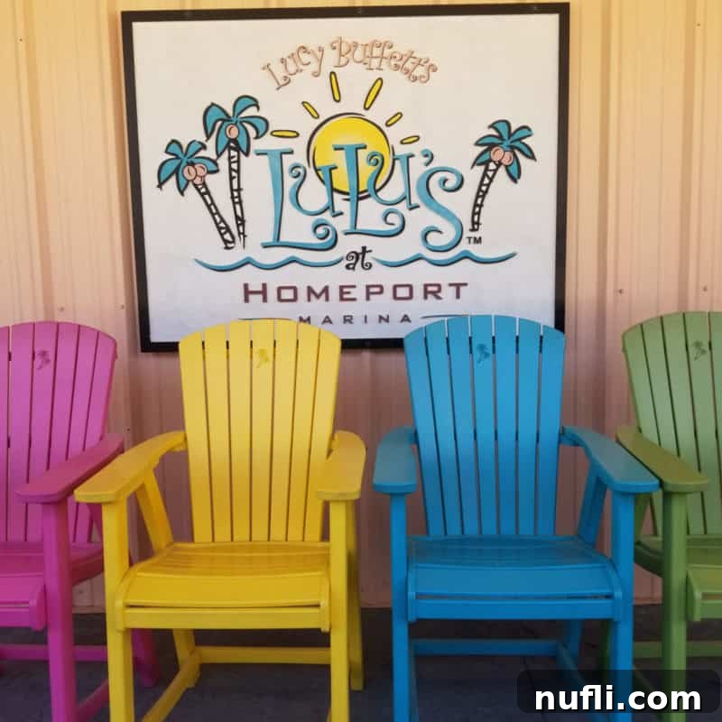 Adirondack chairs positioned below a large LuLu's sign, welcoming guests to the popular waterfront restaurant and entertainment venue.