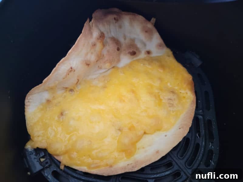 Crispy Air Fryer Quesadillas 5 cooked air fryer quesadilla in the air fryer basket
