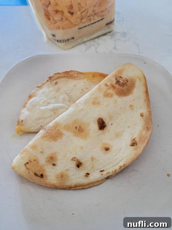 Crispy Air Fryer Quesadillas 8 two air fryer quesadillas on a white plate