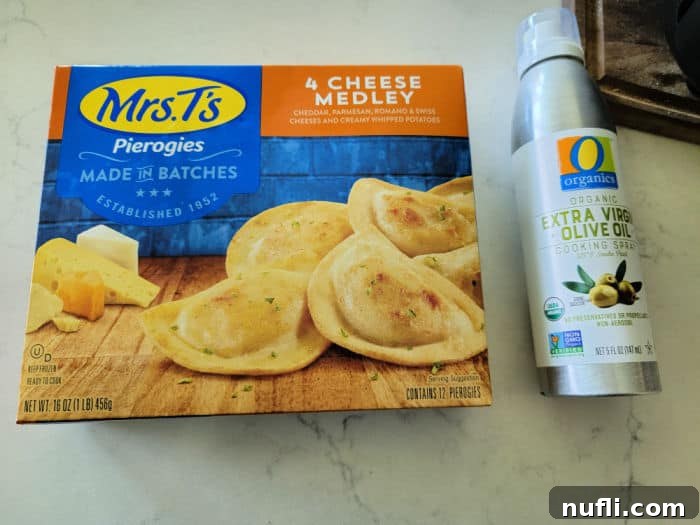 Crispy Air-Fried Pierogies 3 A box of Mrs. T's 4 Cheese Medley frozen pierogies beside a bottle of olive oil spray, essential ingredients for air frying.