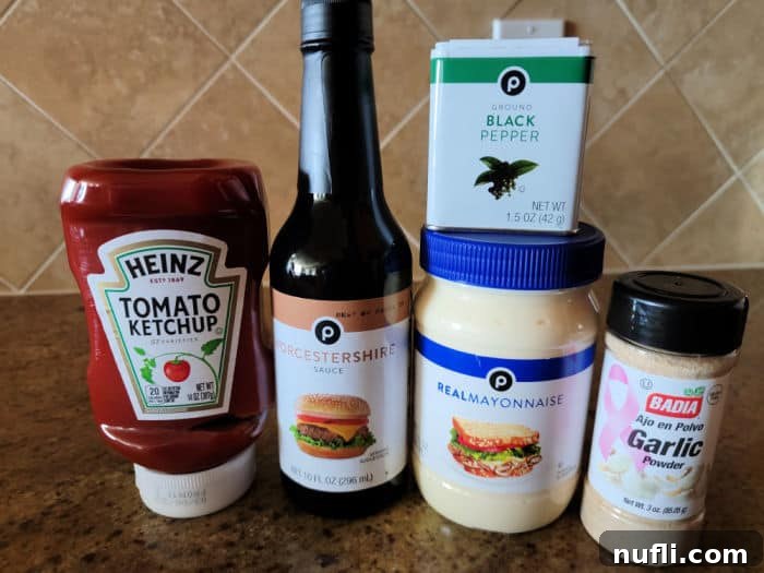 Ketchup, Worcestershire sauce, mayonnaise, black pepper, and garlic powder on a brown counter