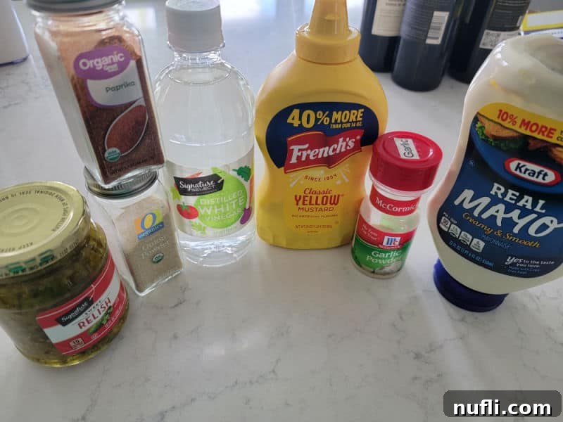relish, onion powder, paprika, vinegar, mustard, garlic powder, mayo on a white counter 