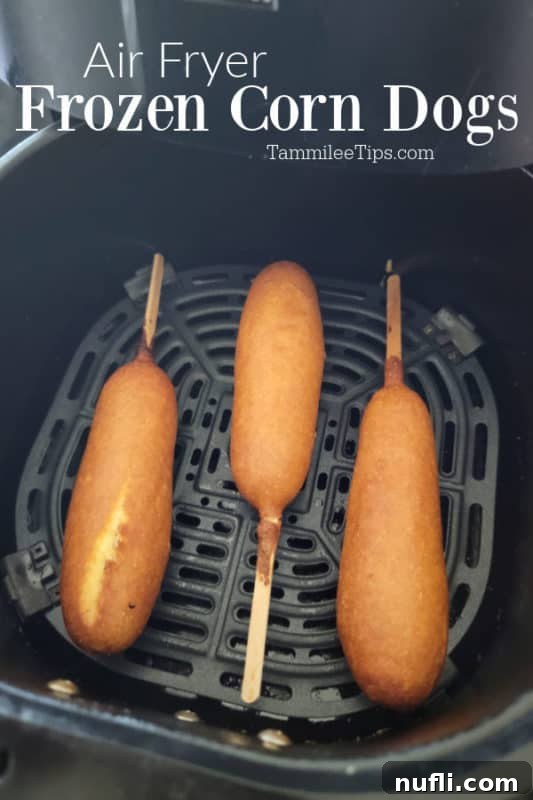 Crispy Air Fryer Frozen Corn Dogs 2 Air fryer frozen corn dogs over an air fryer basket with three air fried corn dogs