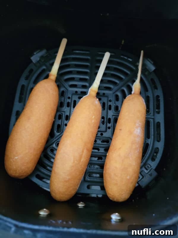 Crispy Air Fryer Frozen Corn Dogs 4 frozen corn dogs in an air fryer basket