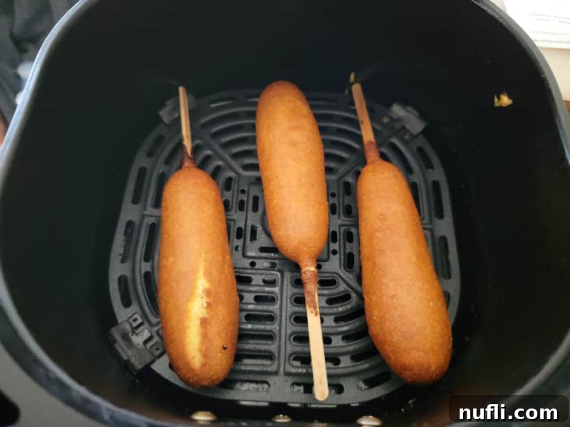 Crispy Air Fryer Frozen Corn Dogs 5 air fried corn dogs in an air fryer basket