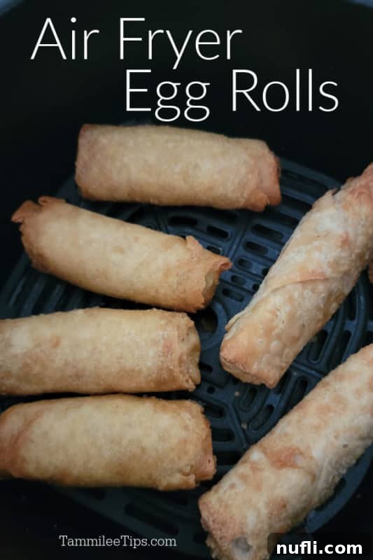 Crispy air fryer egg rolls in an air fryer basket, ready to be served.