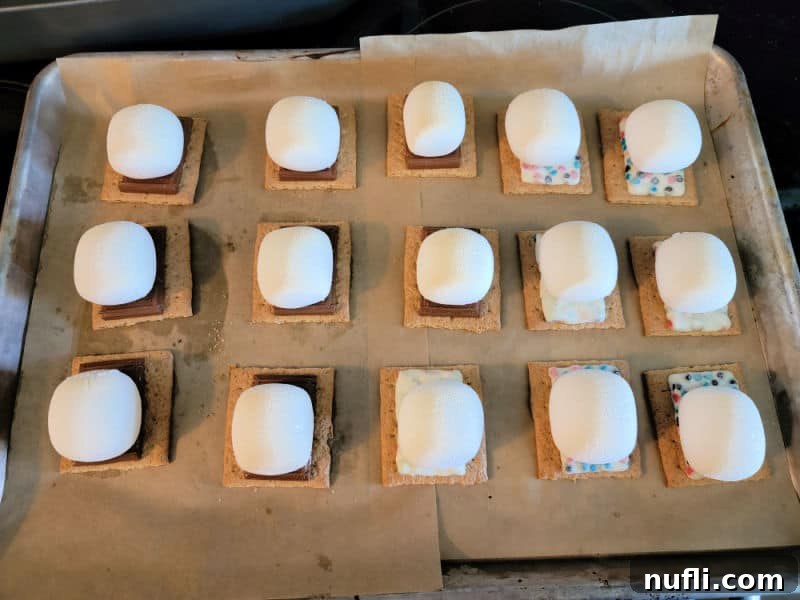 Oven smores on parchment paper on a baking sheet. 