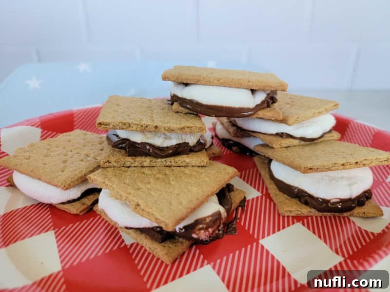 Oven smores on a red checkerboard paper plate with a blue star napkin