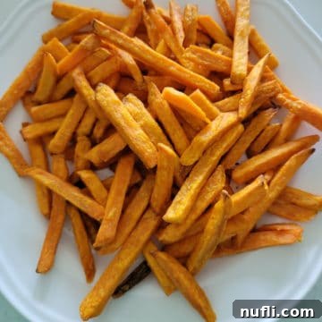 Air fried sweet potato fries on a white plate