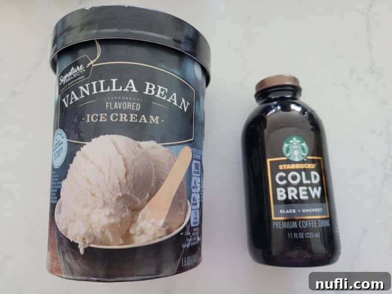 Vanilla Bean ice cream container next to a glass jar of Starbucks cold brew on a marble counter. 