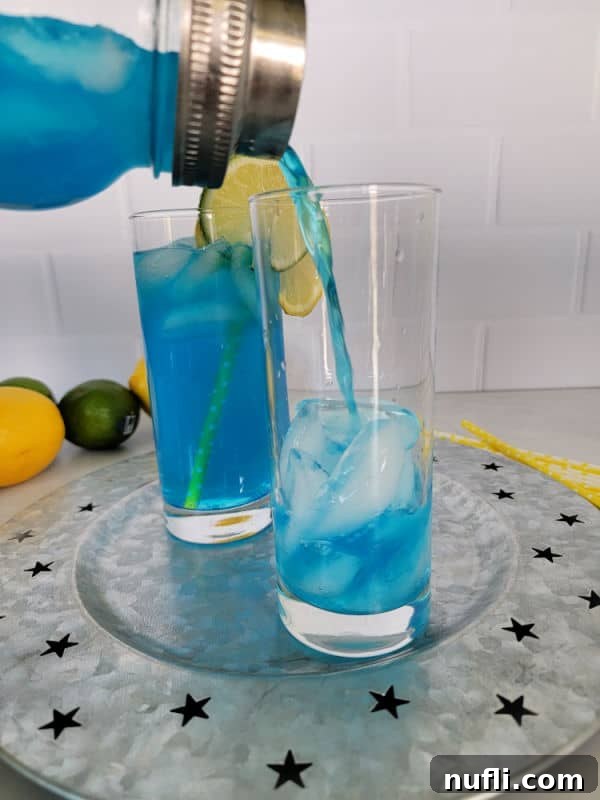 Electric Blue Lemonade pouring into a cocktail glass from a cocktail shaker