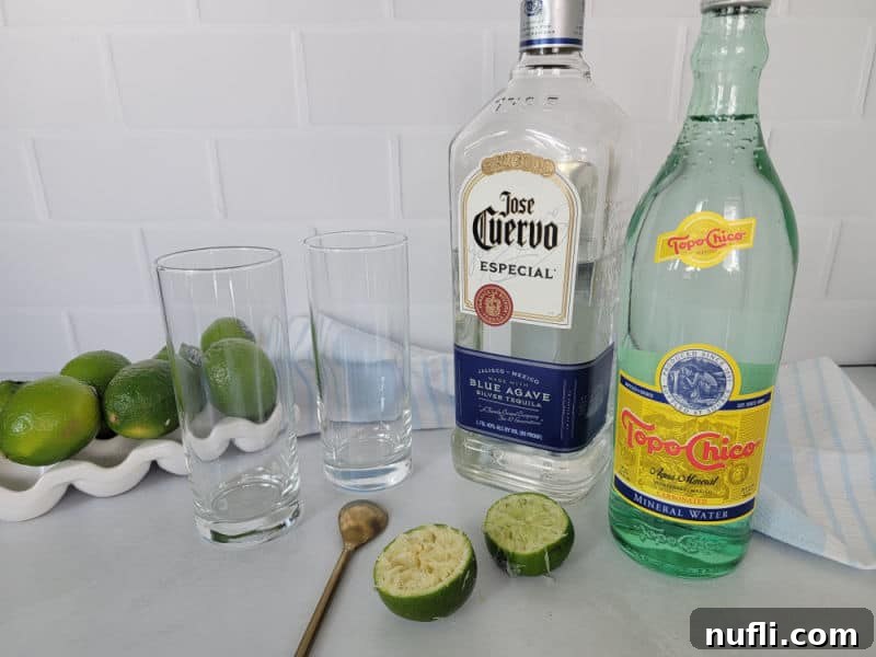 Ranch Water Drink ingredients, limes, tequila, Topo Chico, and 2 glasses