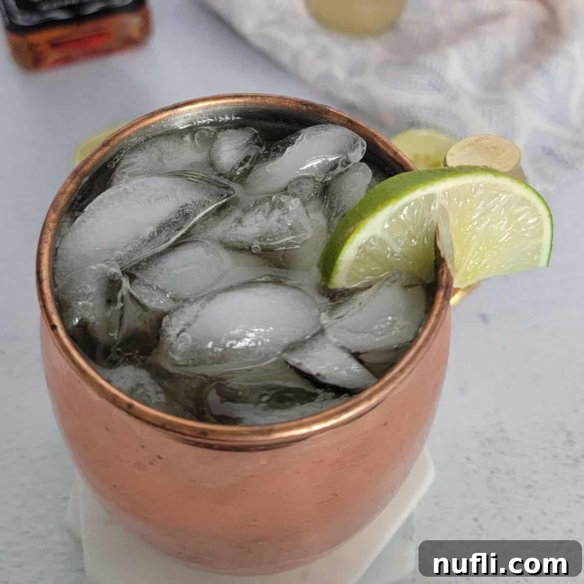 Whiskey Mule in a copper mug with lime wedge