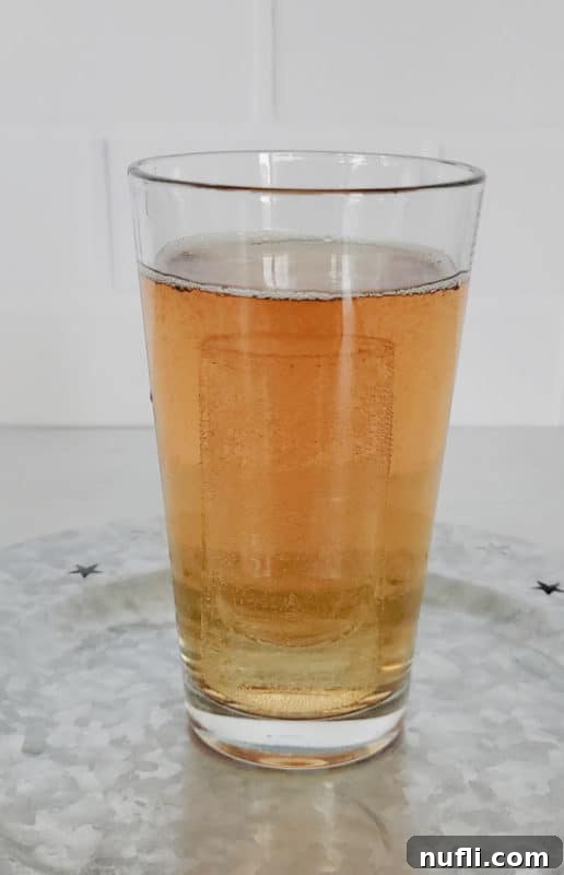 Shot glass inside of a full glass of liquid