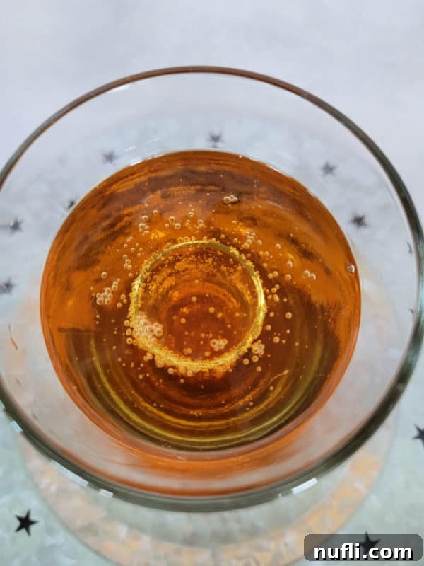 Looking down into a shot glass in a glass with liquid in it