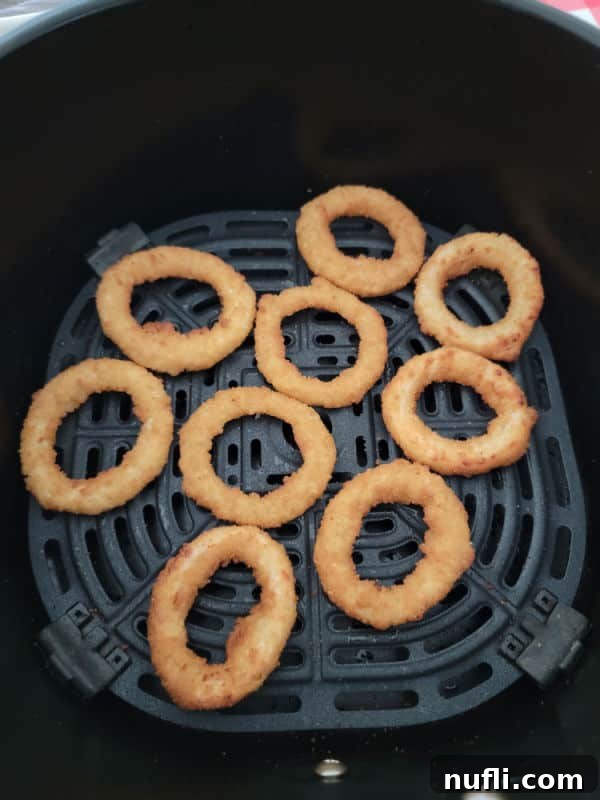 Air fried onion rings in an air fryer basket