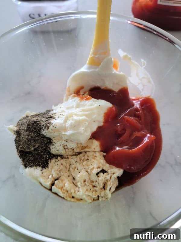Glass bowl with mayo, ketchup and spices. 