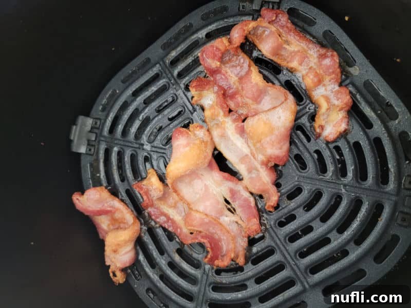Air fried bacon in an air fryer basket
