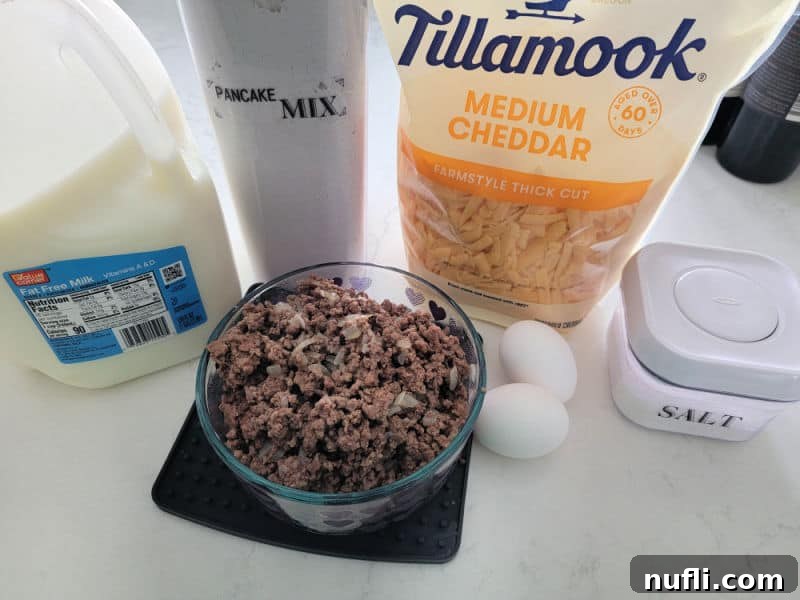Bisquick Impossible Cheeseburger pie ingredients milk, cheddar cheese, ground beef, eggs, salt, and Bisquick mix