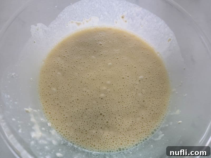 Bisquick mixture for impossible cheeseburger pie in a glass bowl