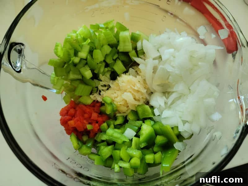 Simple and Delicious Sauerkraut Salad 4 Finely chopped Sauerkraut salad ingredients, including green pepper, celery, onion, and pimentos, gathered in a clear mixing bowl before being combined with sauerkraut and dressing.