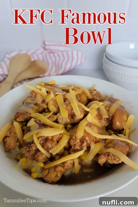 KFC Famous Bowl served in a white bowl, garnished with fresh herbs, next to wooden serving spoons.