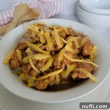 KFC Famous Bowl in a white bowl by wooden spoons