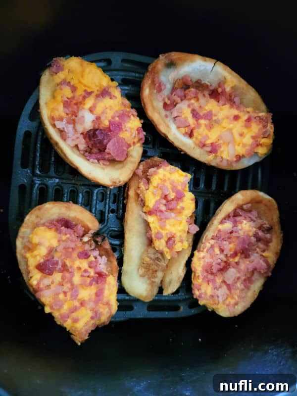 Frozen potato skins in an air fryer basket