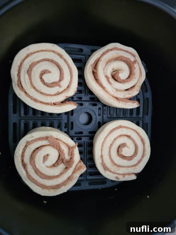 Cinnamon roll dough in an air fryer basket