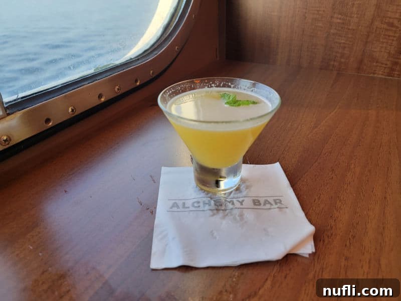 Sweet Heat Chipotle Pineapple Martini 4 Spicy Chipotle Martini on an Alchemy Bar napkin with the ocean in the background