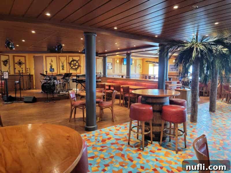 The Ultimate Carnival Cruise Ting Mojito 3 The inviting seating area of the Red Frog Pub on the Carnival Miracle, with a band stage visible in the background.