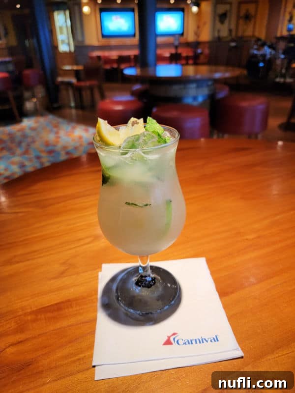 The Ultimate Carnival Cruise Ting Mojito 5 A refreshing Ting Mojito served in a hurricane glass, resting on a Carnival Cruise Line napkin.