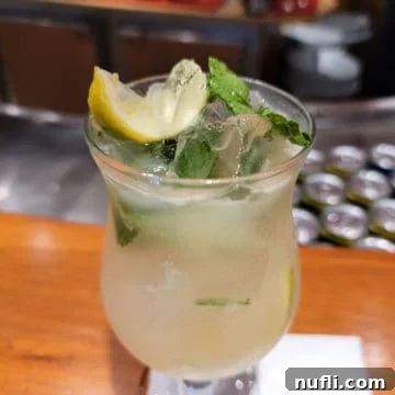 The Ultimate Carnival Cruise Ting Mojito 7 Ting Mojito in a hurricane glass with mint and lemon wedges