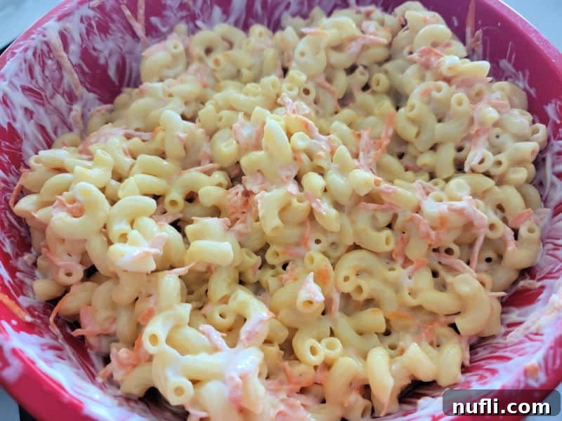 Macaroni with mayo and carrots in a red bowl 