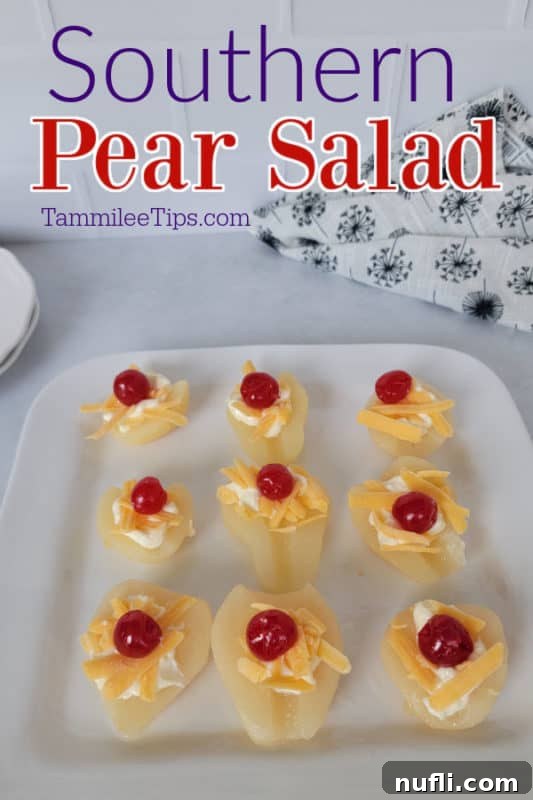 A beautifully arranged Southern Pear Salad with pear halves topped with mayonnaise, shredded cheddar cheese, and a vibrant maraschino cherry, ready to be served.