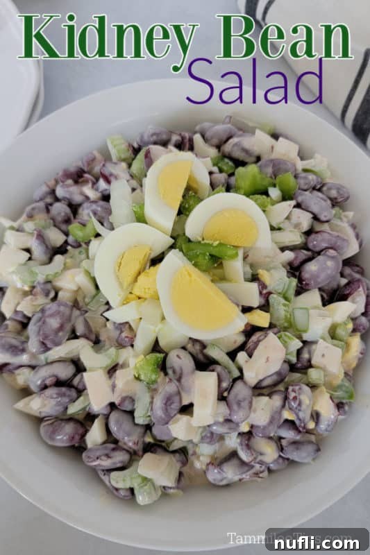 Classic Kidney Bean Salad garnished with hard-boiled egg slices in a white bowl, ready to serve.