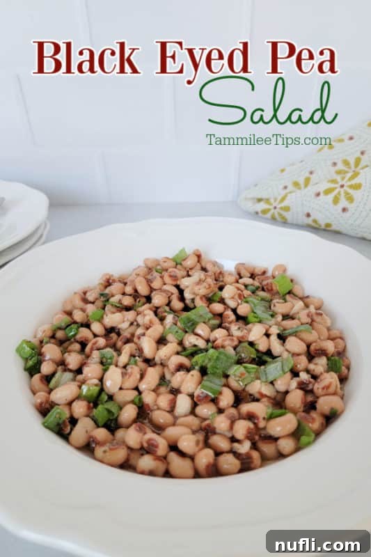 Vibrant Black Eyed Pea Salad in a bowl, garnished with fresh herbs, ready to serve.
