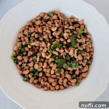 Zesty Black Eyed Pea Medley 6 Black Eyed Pea Salad in a white bowl garnished with green onions