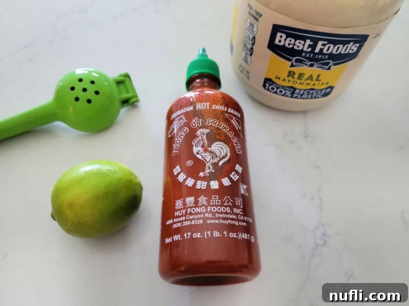 Unlock Umami: Easy Japanese Spicy Mayo 3 Lime juicer, lime, sriracha, best foods real mayo container on a white counter.