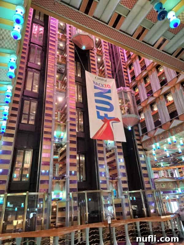 Back to fun Carnival sign hanging near the elevators in the Carnival Miracle atrium