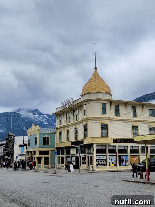 Historic Skagway hotel with other historic buildings and mountains 