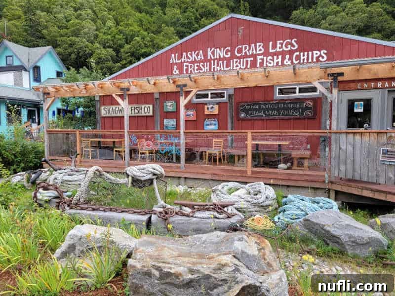 Alaska King Crab Legs and Fresh Halibut Fish and Chips painted on a red buildings with Skagway fish co