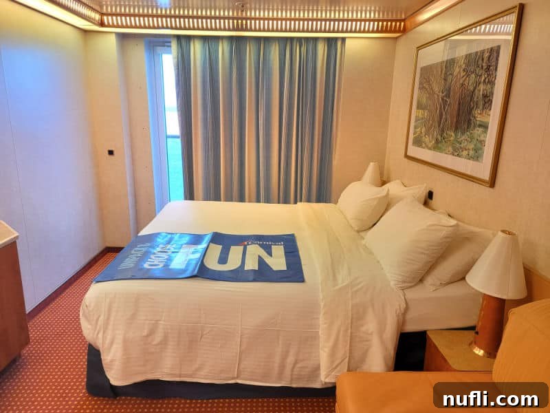 Carnival Miracle stateroom with Choose fun across the bed