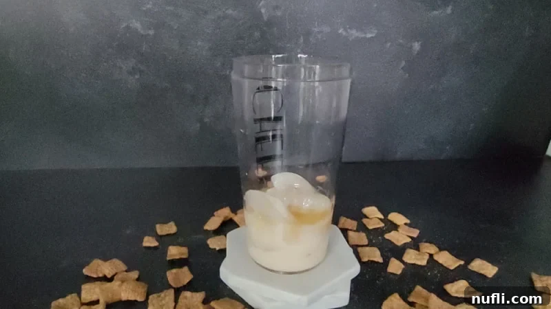 Sweet Cinnamon Crunch Shooter 5 Cocktail shaker with liquid and ice in it net to Cinnamon Toast Crunch Cereal